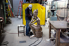 Chasing a bronze sculpture by Anne de Villemejane.